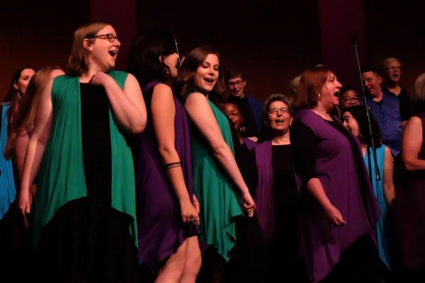 Singers dancing and singing in concert