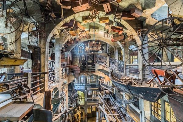 A collection of transportation objects displayed in the air in Mercer Museum