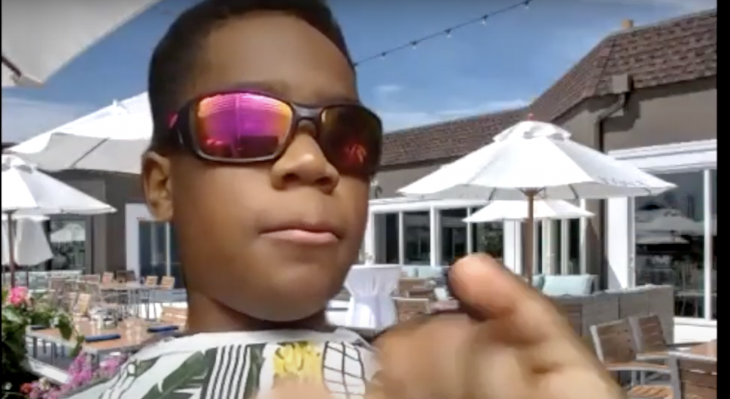 A young, Black boy, wearing sunglasses, who is part of the AWB Juniors Program