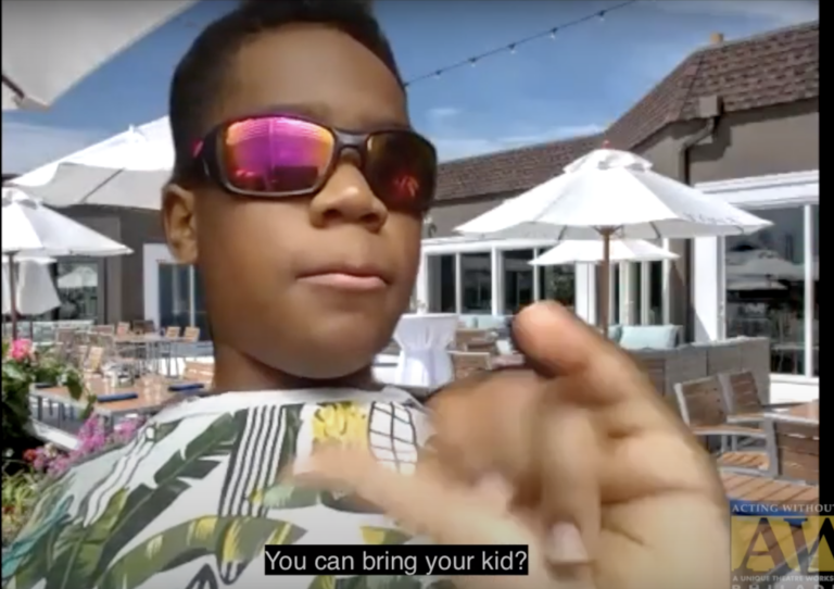 A young, Black boy, wearing sunglasses, who is part of the AWB Juniors Program