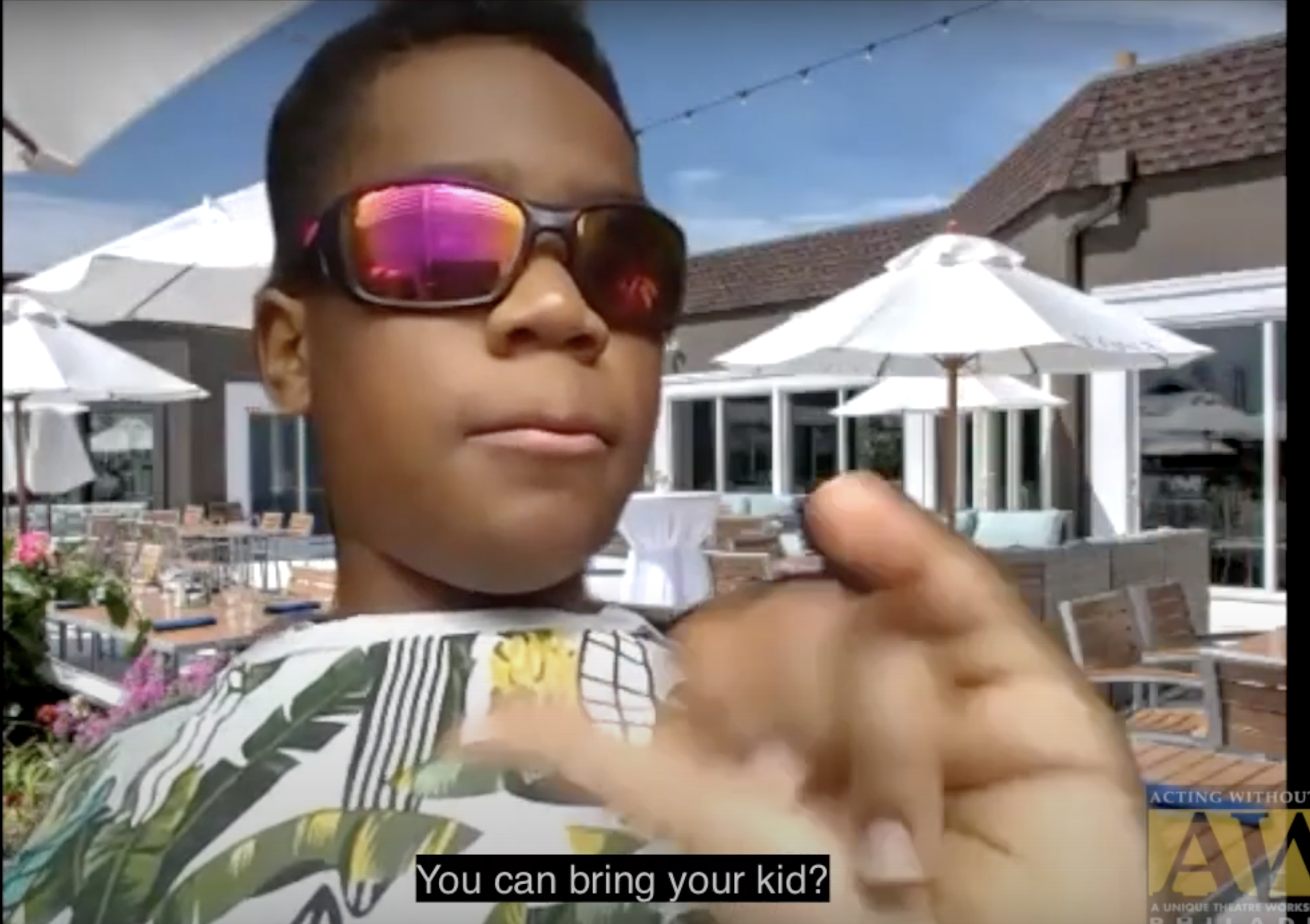 A young, Black boy, wearing sunglasses, who is part of the AWB Juniors Program